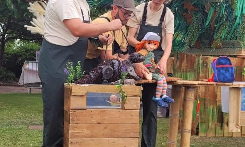 Lyra sitting in deep conversation with Oscar under a swirling willow tree